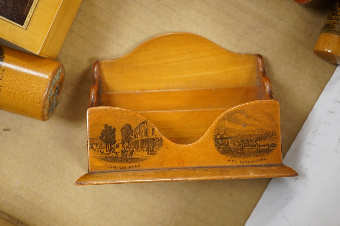 A collection of Scottish mauchline ware boxes, a pin cushion, beaker and a photo frame containing black and white topographical photos